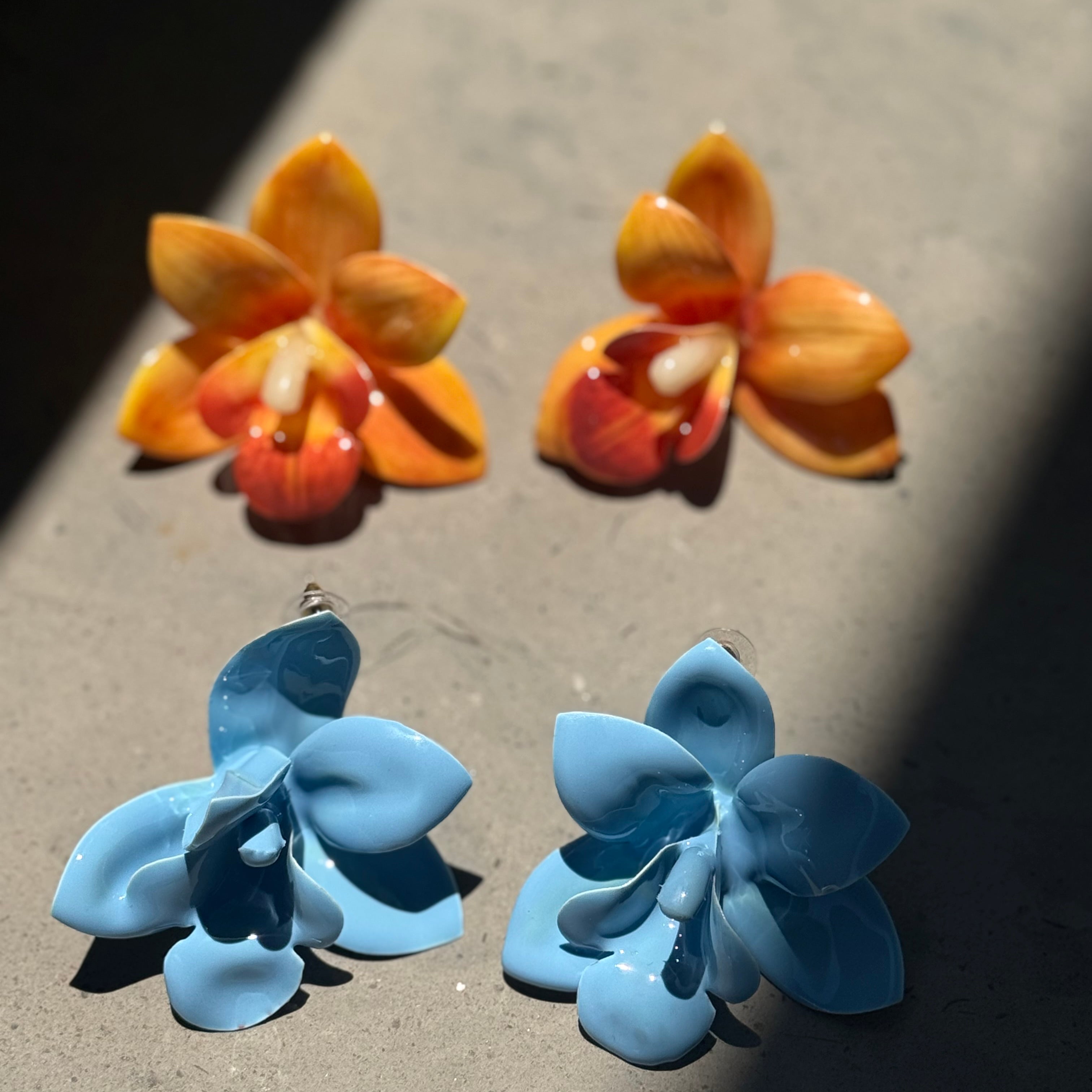 Orange orchid plastic earrings