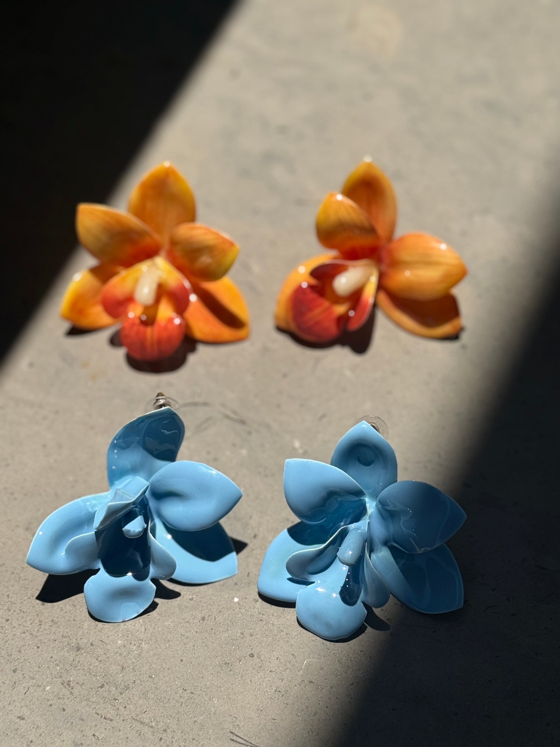 Orange orchid plastic earrings