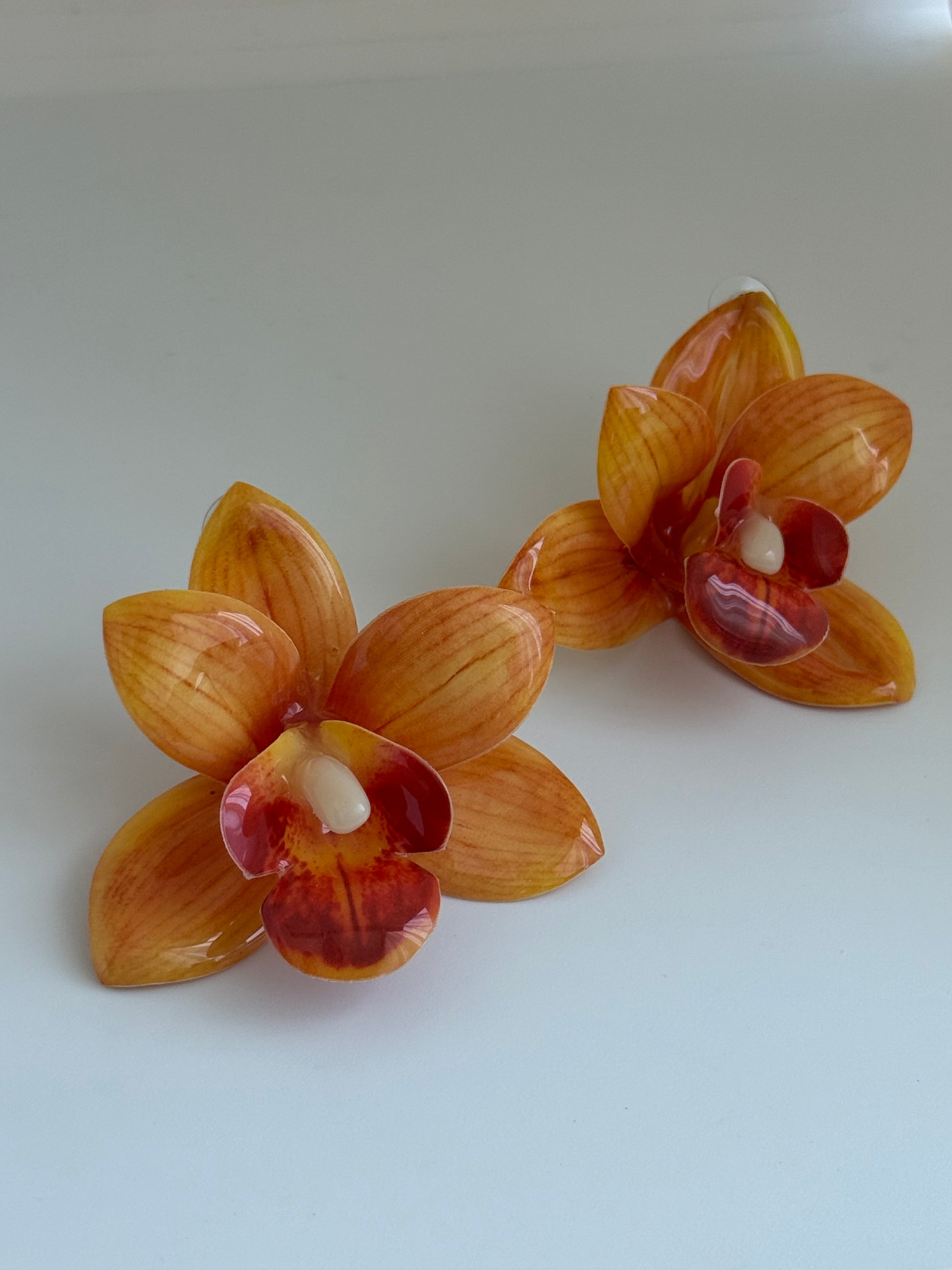 Orange orchid plastic earrings