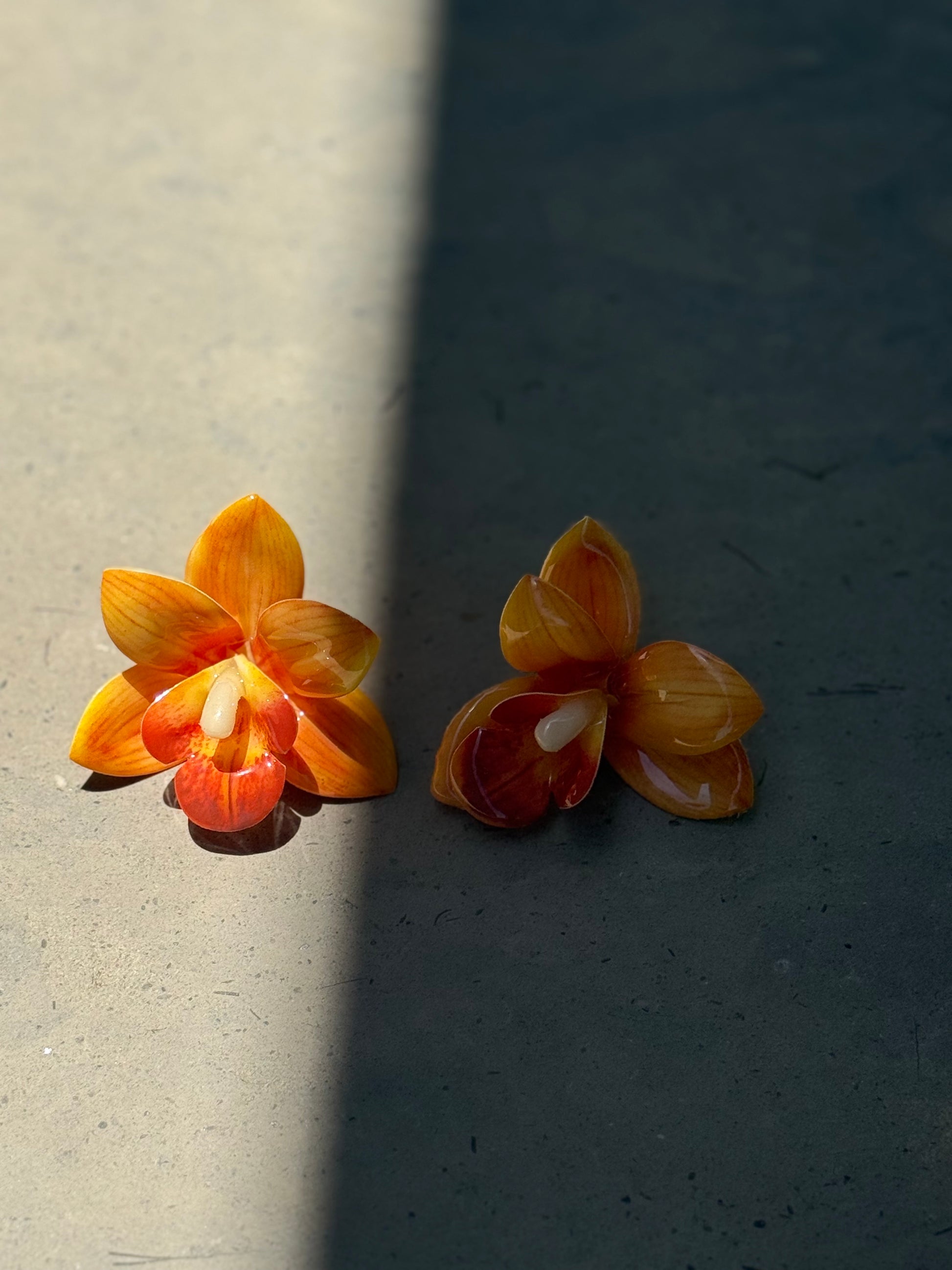 Orange orchid plastic earrings