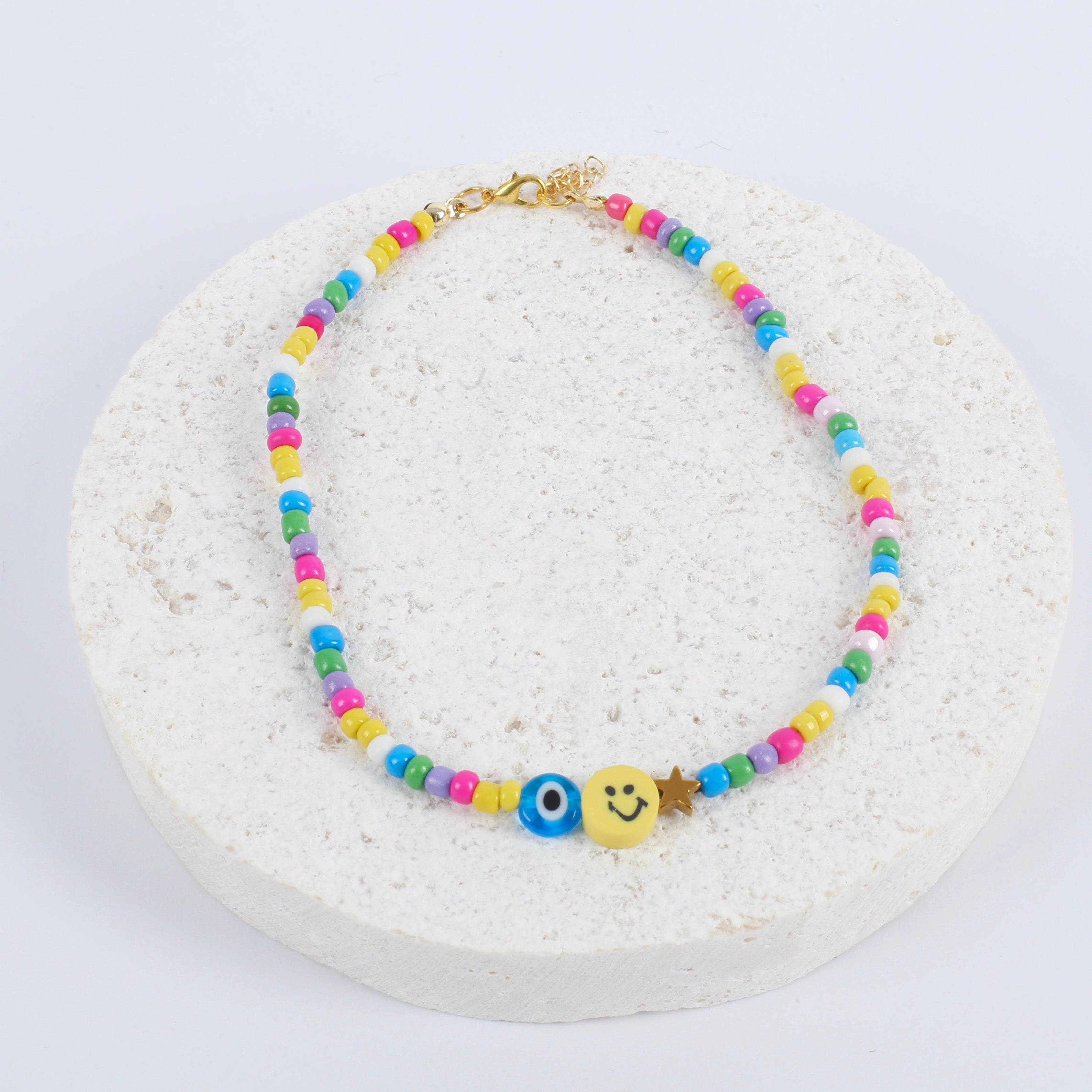 Yellow smiley / evil eye necklace