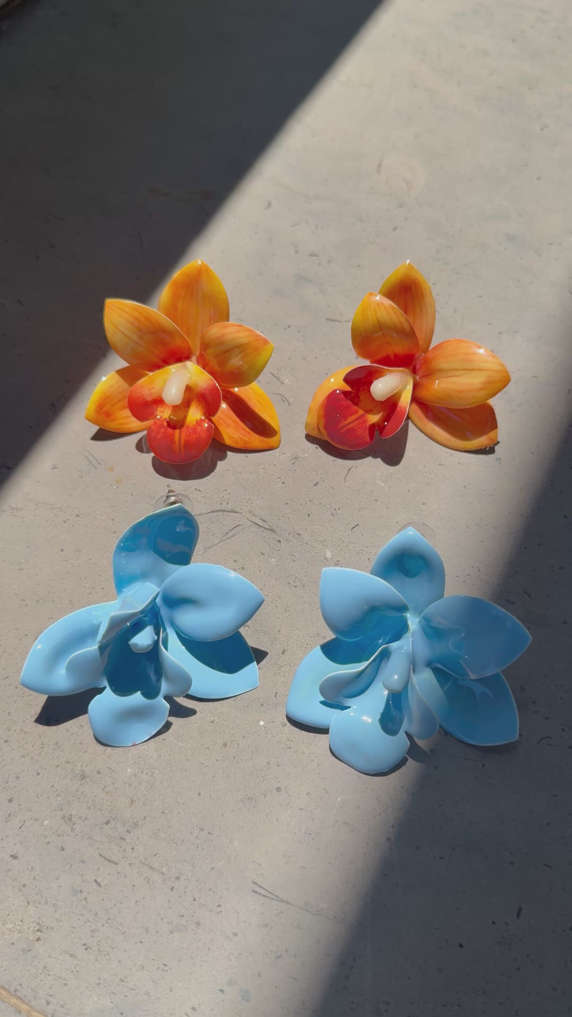 Orange orchid plastic earrings